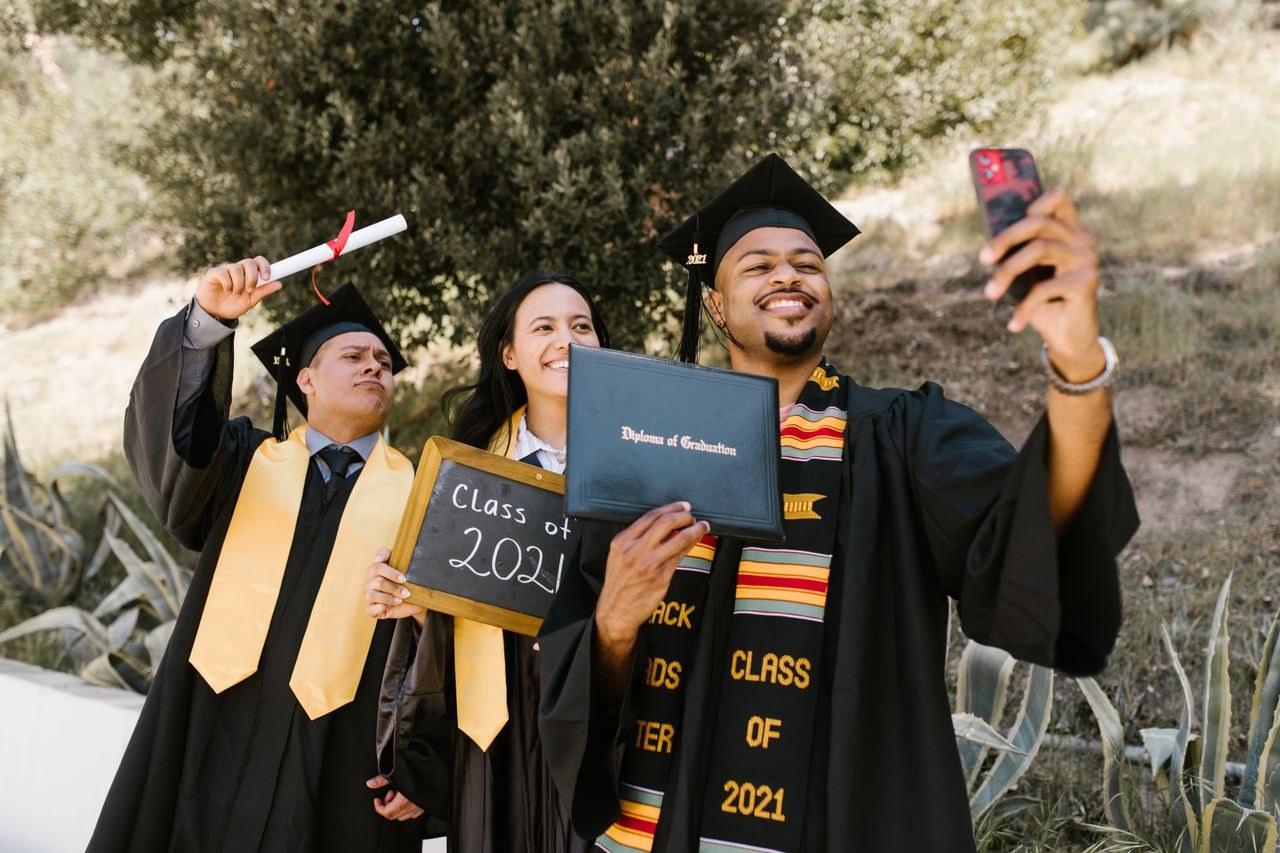 Graduates celebrating with their diplomas